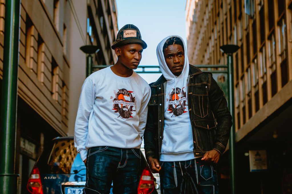 two people wearing a customized hoodie and tee that were blank originally