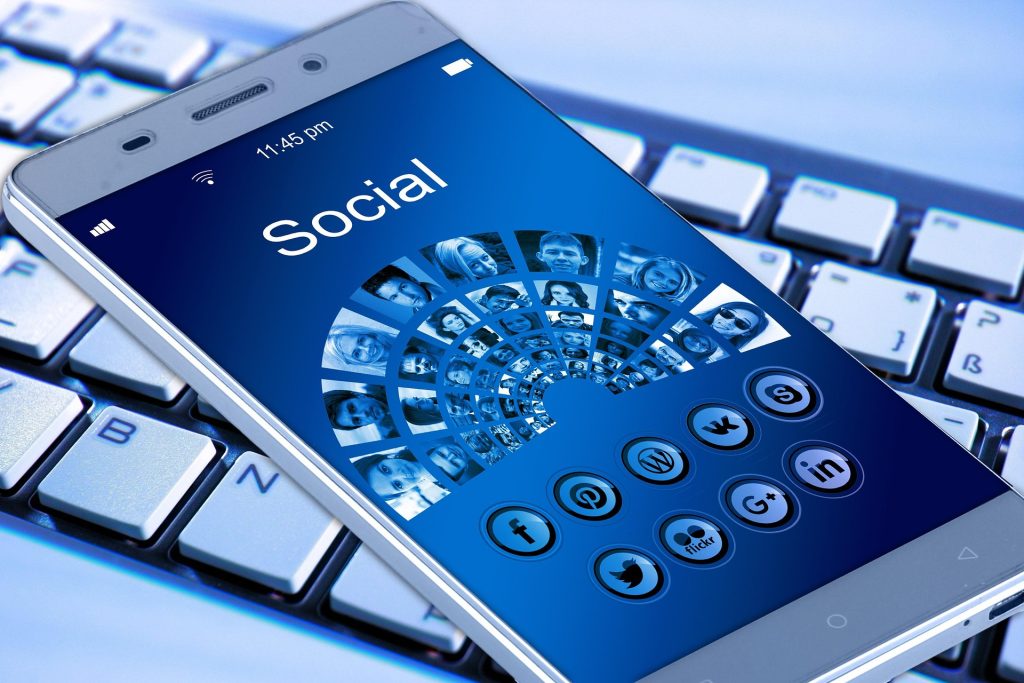 a smartphone (mobile phone or cell phone) with various apps and pics