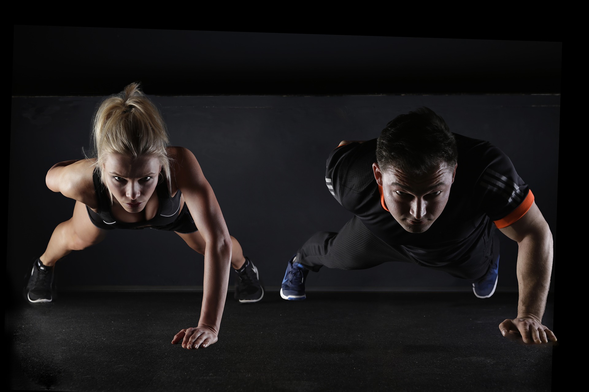 a man and woman doing a one-arm push-up